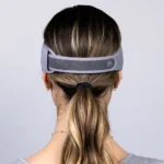 A photo of the back of a blond woman in a gray shirt wearing the SONU band which is a gray band that stretches around her head like a headband