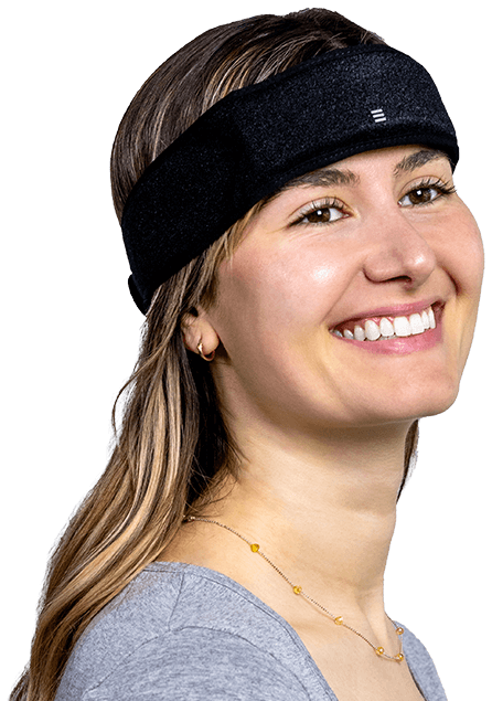 A photo of a smiling blond woman in a gray shirt wearing the SONU band which is a black band that stretches around her head like a headband